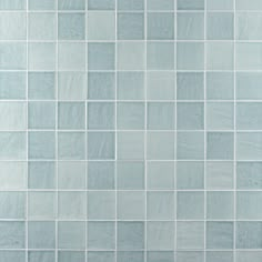 a blue tiled wall with white tiles on it