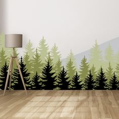 a room with a wooden floor and large wall mural depicting trees in the forest,