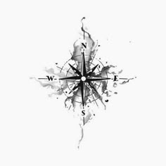 a black and white drawing of a compass on a white background with watercolor splashes