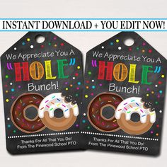 two donuts with sprinkles are on black tags