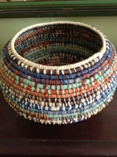 a woven basket sitting on top of a wooden table