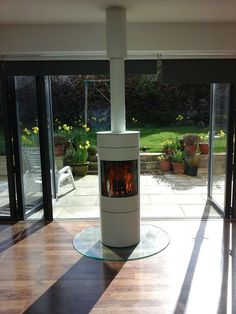 a large white stove sitting inside of a living room next to a sliding glass door