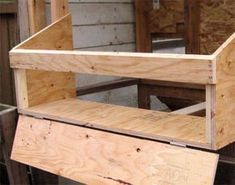 a wooden shelf sitting on top of a pile of wood