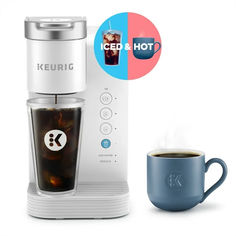 a keurig coffee maker next to a cup of coffee and an iced hot beverage