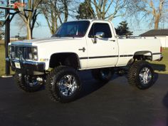 a white pickup truck parked in a parking lot