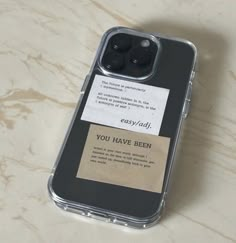 an iphone case with a note attached to it