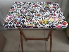 a table covered with lots of stickers on it's top and bottom half