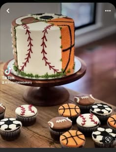 cupcakes are arranged on a table with a cake in the shape of a basketball