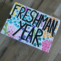 a card that says freshman year on it with flowers and leaves around the edges