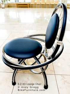 a black chair sitting on top of a tiled floor