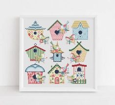 a cross stitch pattern with birds and birdhouses on the outside, in front of a white background