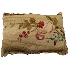 an embroidered pillow with flowers on it