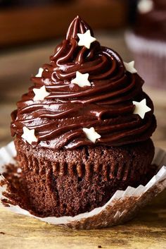 a cupcake with chocolate frosting and stars on top