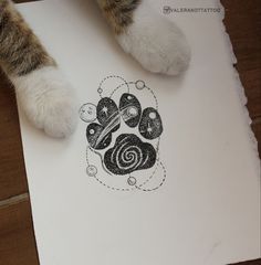 a cat's paw is on top of a piece of paper with an image of a dog's paw