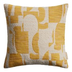 a yellow and white pillow with an abstract design on the front, in shades of beige