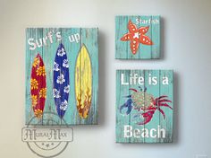 three wooden signs that say surfs up, life is a beach and starfish