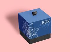 a blue box with a flower design on the front and side, against a pink background