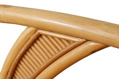 a close up view of the back end of a wooden chair with curved sides and bent legs