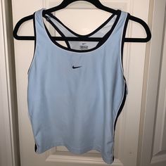 Light Blue, Semi Cropped Tanktop. Built In Sports Bra. Almost Brand New Condition Light Blue Sporty Moisture-wicking Top, Sporty Light Blue Moisture-wicking Tops, Nike Sporty Sleeveless Tops, Sporty Sleeveless Nike Top, Light Blue Moisture-wicking Athleisure Top, Moisture-wicking Light Blue Workout Top, Nike Sleeveless Sportswear Top, Casual Blue Tops For Gym, Nike Tank Top For Gym