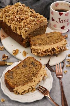 two slices of cake on plates next to a cup of coffee and fork with spoons