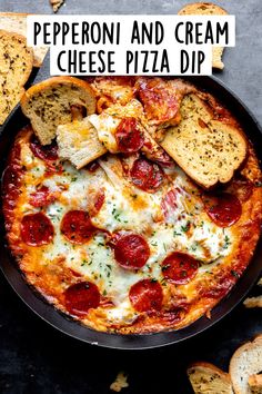 pepperoni and cream cheese pizza dip in a cast iron skillet with garlic bread on the side