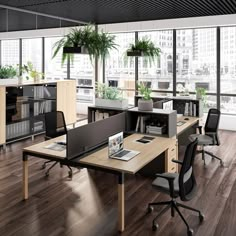 an office with large windows, desks and chairs