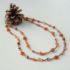 Autumn is just around the corner! This double-strand beaded necklace is made of red agate stones, aventurine chips, Czech glass, crystal, glass seed beads and silver-tone accent beads. It is finished with silver-tone stainless steel chain. Orange Multi-strand Polished Beaded Necklaces, Orange Multi-strand Beaded Necklace With Polished Beads, Orange Multi-strand Polished Beaded Necklace, Brown Czech Glass Beaded Necklaces With Gemstone Beads, Brown Czech Glass Gemstone Beaded Necklaces, Brown Czech Glass Beaded Necklace With Gemstone Beads, Brown Beaded Necklace With Czech Glass And Gemstone Beads, Orange Czech Glass Beaded Necklaces, Orange Carnelian Beaded Necklace With Colorful Beads