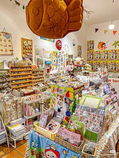 the interior of a children's store with lots of toys on display and stuffed animals hanging from the ceiling