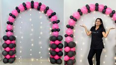 a woman standing in front of an arch made out of balloons and black and pink balls