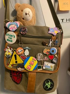 New bag arangment!! (Guess my special intrests challenge hard‼️‼️) Bag Patches Ideas, Loungefly Bag Aesthetic, Bag With Pins And Patches, Clothing Patches Ideas, Messenger Bag With Pins, Apocalypse Bag, What's In My Tote Bag