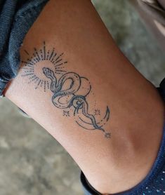 a woman's arm with a tattoo on it that has an image of a snake