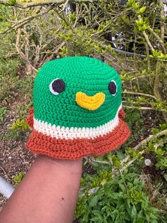 This Mallard Duck hat is the perfect spring/summer accessory.  Available in sizes newborn to adult XL (Model is wearing size Size 3-5 years) Made from 100% acrylic yarn (As each hat is handmade, there may be a small variance in the size/ colour of the product) This piece is made to order. It will take 1-2 weeks for your order to be hand crafted (with love) and then shipped.   Custom colours are available upon request. Send an email to danae.handmade@googlemail.com with your choice of colours, an Playful Adjustable Crochet Hat, Cute Crochet Hat With Curved Brim, Green Yarn Hat With Short Brim, Green Yarn Bucket Hat With Curved Brim, Green Adjustable Crochet Beanie, Cute Yarn Cap, Playful Crochet Adjustable Bucket Hat, Playful Crochet Beanie For Spring, Playful Crochet Beanie Hat For Spring