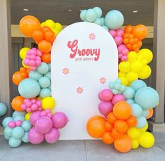 there is a sign that says grooy on it and balloons all over the place