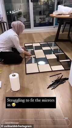 a person kneeling down on the floor in front of a mirror with black and white squares