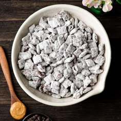 a white bowl filled with dog food next to flowers