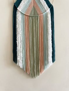 a multicolored wall hanging on a white wall