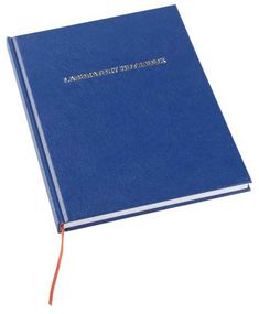 a blue book with writing on the front and back cover is open to show an orange cord