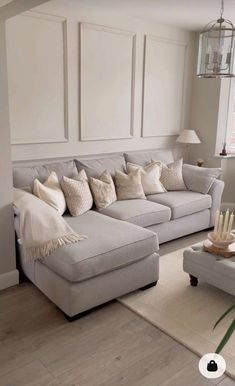 a living room filled with lots of furniture and decor on top of a hard wood floor