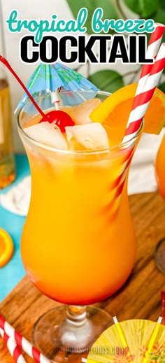 a tropical breeze cocktail is garnished with orange slices and an umbrella for the drink