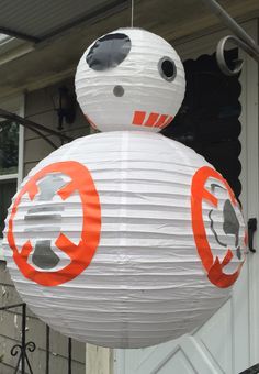 a star wars bbg paper lantern hanging from the side of a house