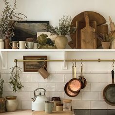 pots and pans are hanging on the wall