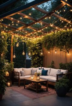 an outdoor living area with lights strung from the ceiling