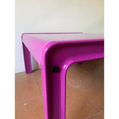 a purple table sitting on top of a tiled floor