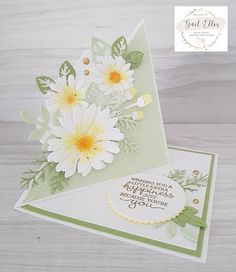 a close up of a greeting card with flowers on the front and back of it