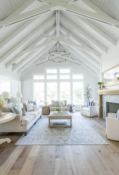 a living room filled with furniture and a fire place in front of a large window