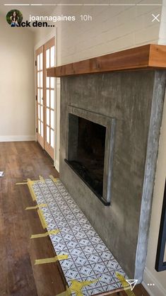 a fireplace being installed in a living room with yellow tape on the floor next to it