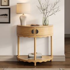 a wooden table with a lamp and vase on it