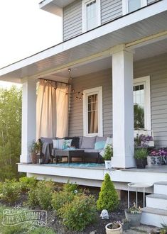 the porch is decorated with plants and flowers