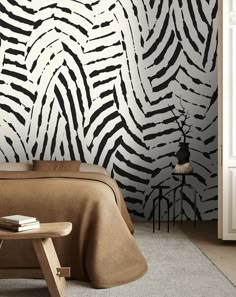 a zebra print wallpaper in a bedroom with a bed and stool next to it