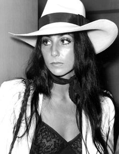 black and white photograph of a woman wearing a cowboy hat